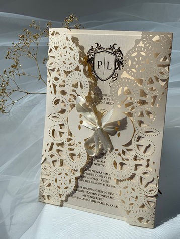 Laser cut gatefold · Crest monogram · Ribbon